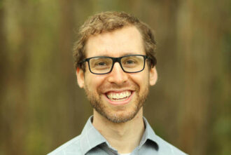 Ben Nachman, a person with light brown hair and glasses.