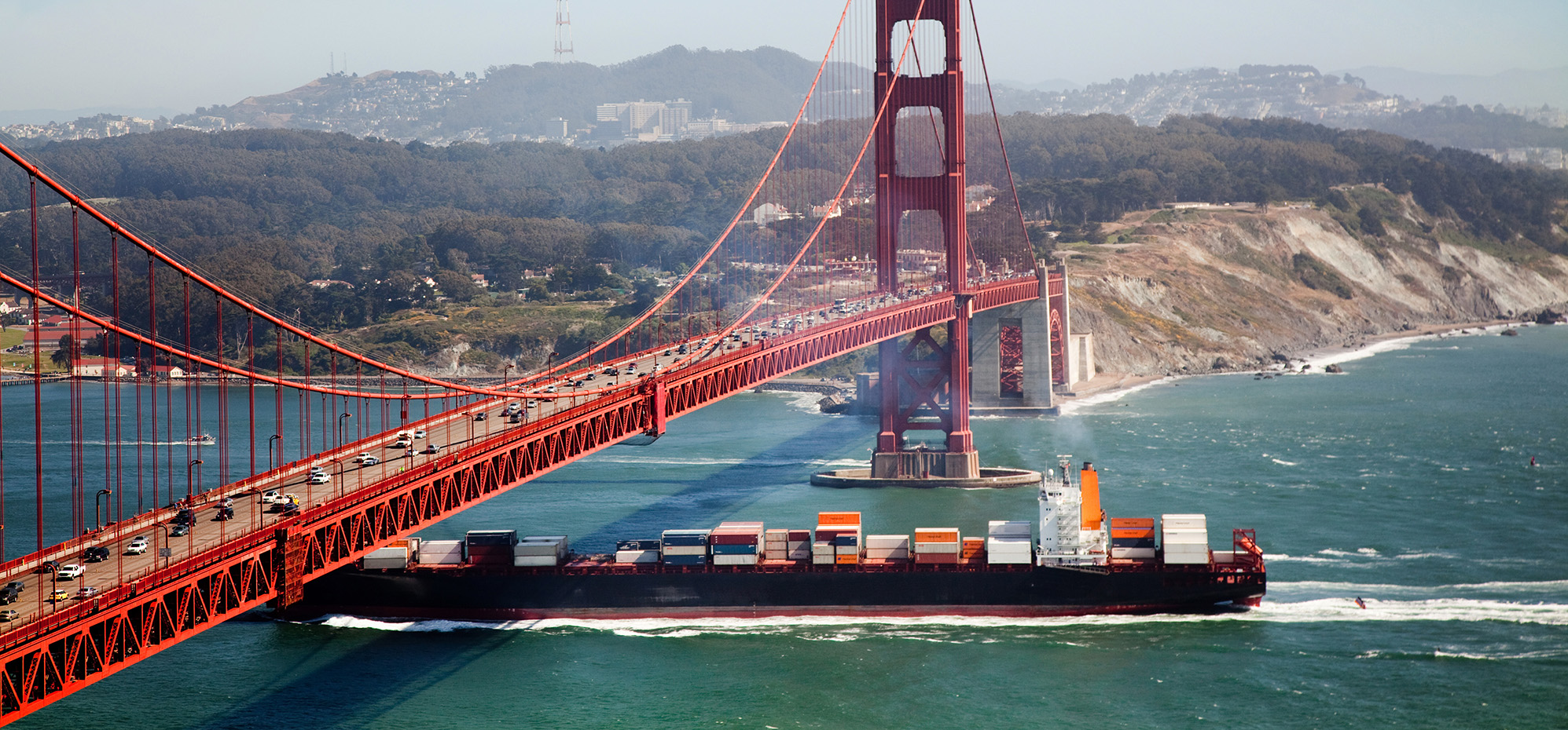 Container ship under Golden Gate Bridge in San Francisco.